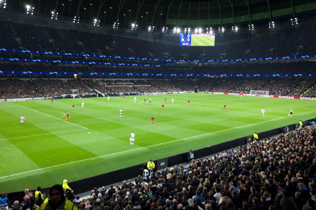 Inside the Tottenham Hotspur Stadium looking at the pitch at an evening match